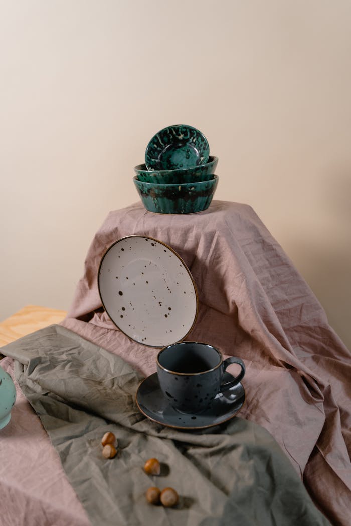 heros-img Decorative arrangement of ceramic dishes and fabric for a rustic aesthetic.